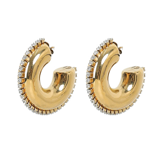 The Half Circle Hoop Earrings are chunky, 24K gold plated hoops with a smooth, curved design and a row of sparkling white gemstones adorning the outer edge.