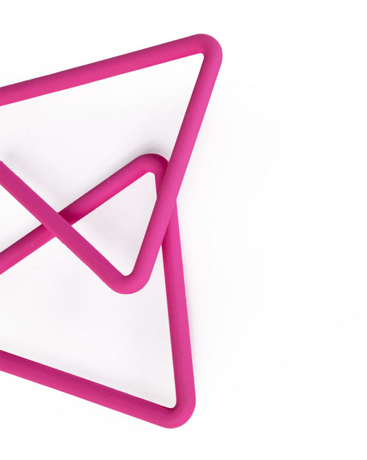 Two pink, triangular rubber shapes overlap on a white background, evoking the minimalist design of Triangle Earrings—an affordable luxury accessory. The composition is concentrated in the lower left and center.