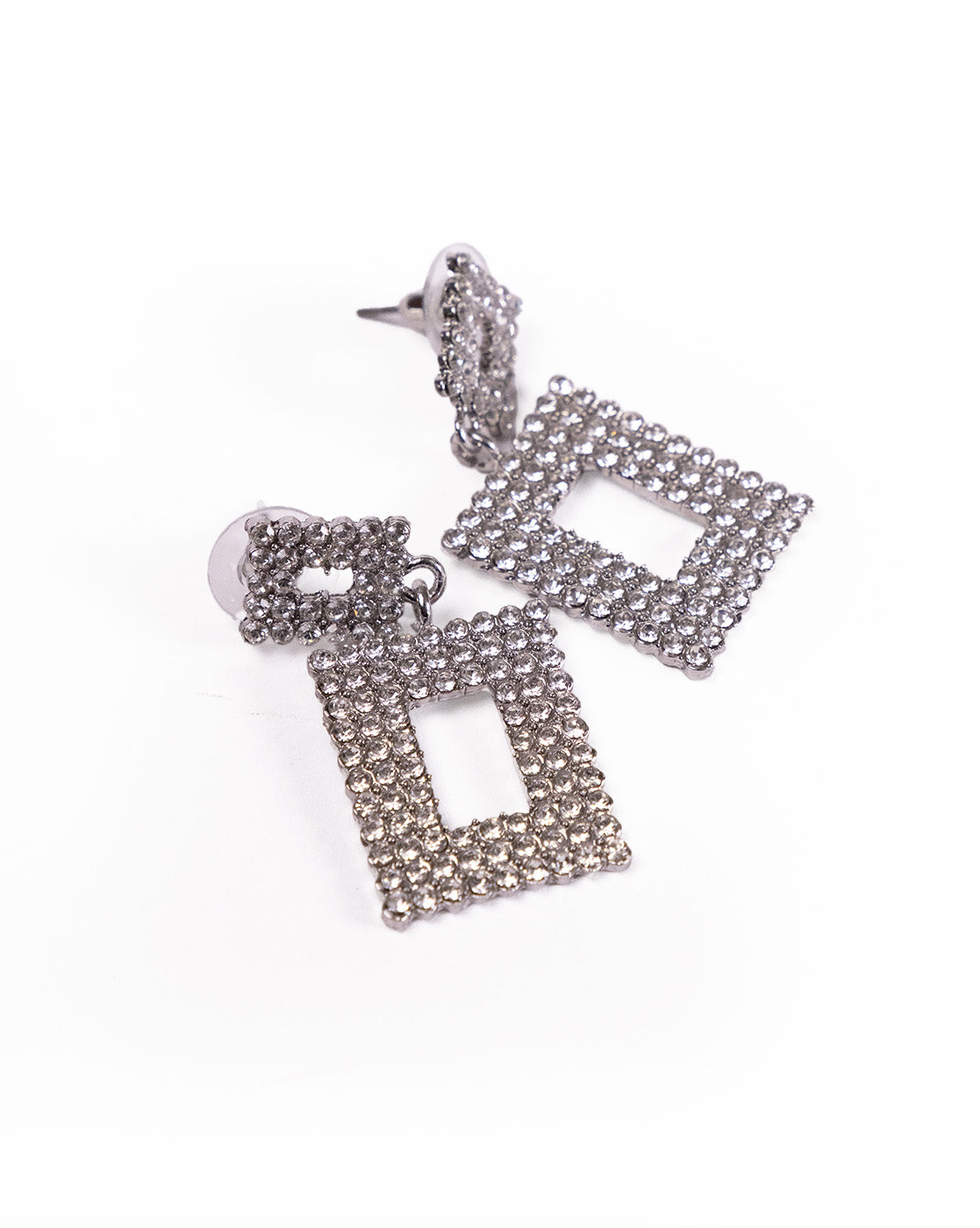 Geometric rhinestone earrings featuring silver dangle designs with square and rectangular shapes, adorned with sparkling stones, are displayed against a white background.