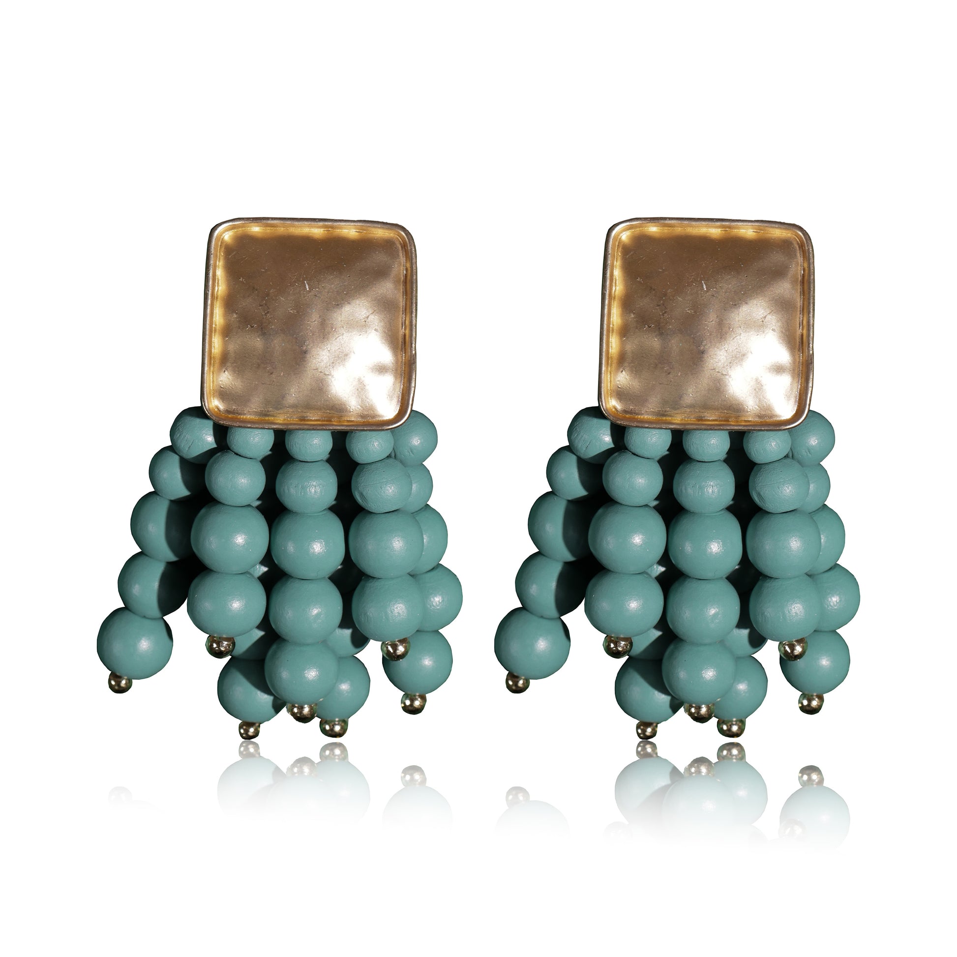 The Beady Blue and Gold Earrings feature square gold-plated tops with multiple strands of clustered teal beads, offering a modern, bold look with a reflective, minimalistic style.