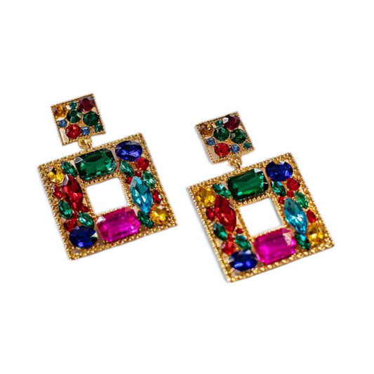 The Esmeralda Earrings are gold-plated, square statement earrings with a cut-out center, a small square stud on top, and multi-colored gemstones in red, green, blue, and pink.