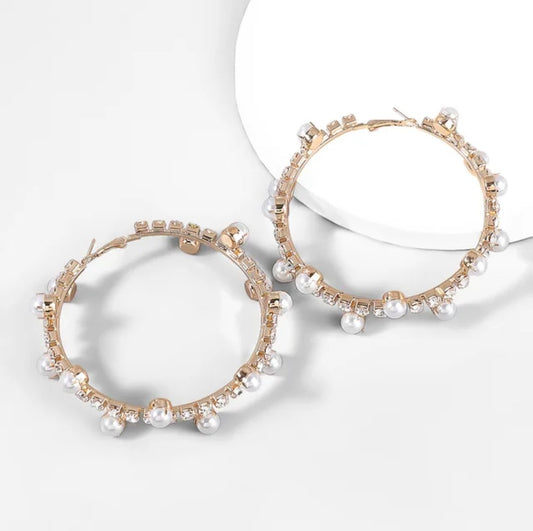 The Gold Pearl and Crystal Hoops feature gold plating adorned with small pearls and clear crystals, shown on a white background with soft shadows—an elegant choice for your luxury jewelry collection.
